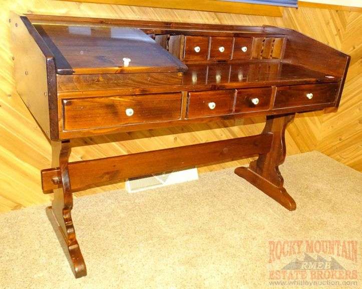 Dark pine desk with drawers, pigeon holes, lift top compartment and