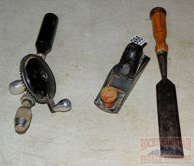 Vintage hand crank drill with bits in handle, small block plane and 11/2" wood chisel. All for