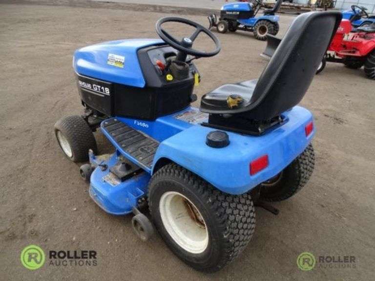 New Holland GT18 Tractor, w/ 48in Snowplow, 48in Under Mount Deck Mower