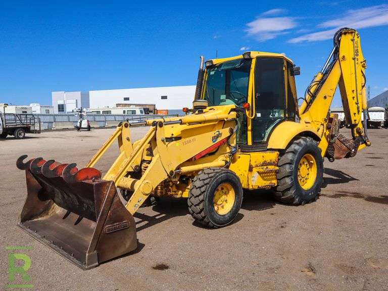 Komatsu WB1502 4WD Loader/Backhoe Roller Auctions