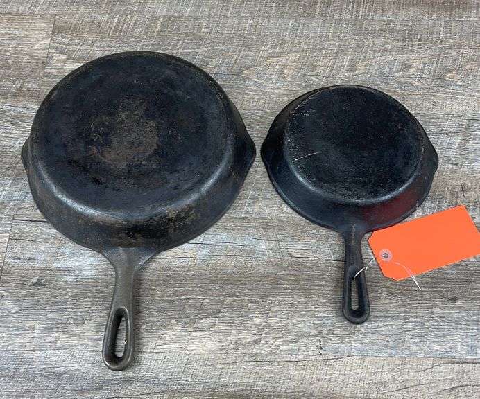 2 unmarked cast iron skillets Schneider Auctioneers LLC