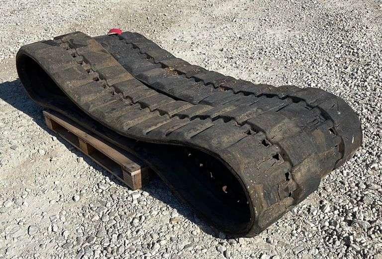 Pair of used matched skid steer tracks Schneider Auctioneers LLC