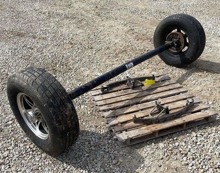 6lug trailer axle w/ springs & wheels Schneider Auctioneers LLC