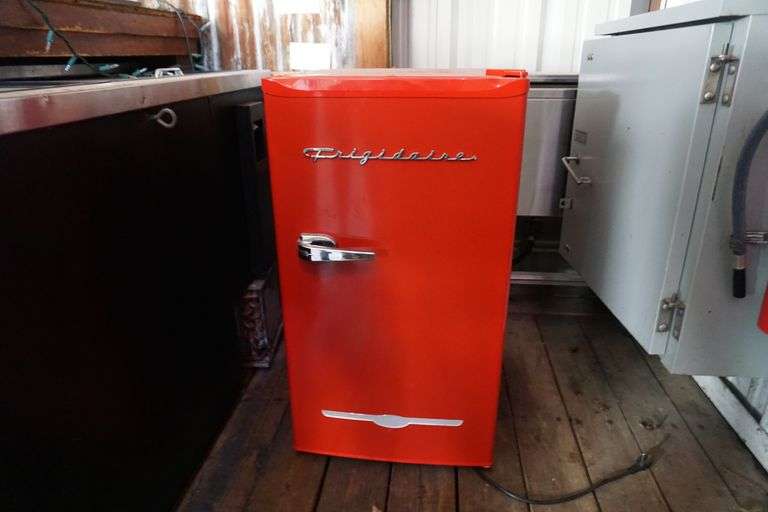 Red Frigidaire mini fridge World Wide Auction Inc